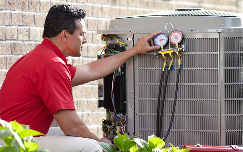 A man working on a AC